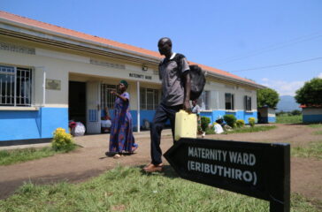 A man walks past a ward at Kasese Rukoki Hospital that was recently up graded from Health Centre 1V - Copy