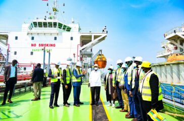 President Museveni chats with Ravi and other officials after commissioning Lake Victoria Logistics at Kawuku on Thursday. PPU Photo