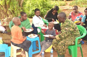 UPDF-SOLDIER-SHAREING-A-MEAL-WITH-RESCUED-CHILD-ABDUCTEE-IN-LUNA-SECTOR-4