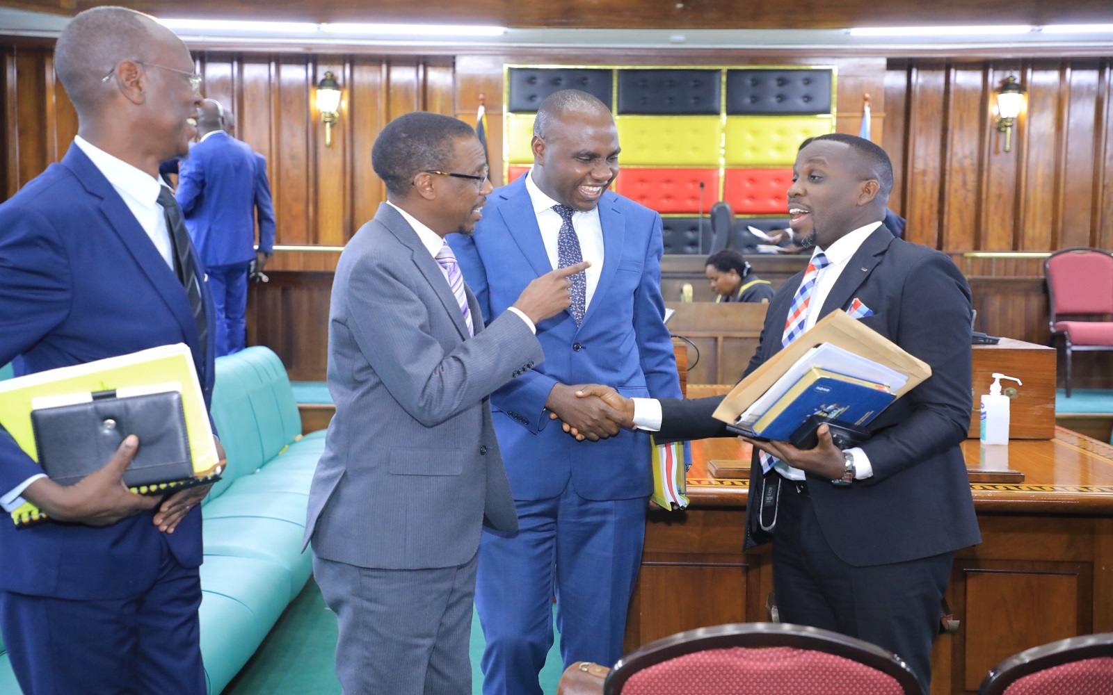 The Attorney General, Kiryowa Kiwanuka (2nd L) and State Minister for Finance, Musasizi interact with the LoP, Joel Ssenyonyi (R) as Hon. Achia looks on