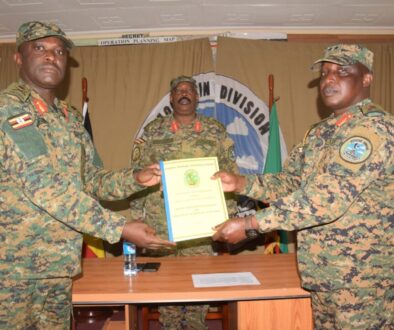 From-right-the-out-going-MTN-DIV-Comdr-Maj-Gen-James-Birungi-handing-over-a-report-to-the-incoming-MTN-DIV-Comdr-Brig-Gen-P-Muwonge-.-left-2048x1446