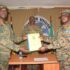 From-right-the-out-going-MTN-DIV-Comdr-Maj-Gen-James-Birungi-handing-over-a-report-to-the-incoming-MTN-DIV-Comdr-Brig-Gen-P-Muwonge-.-left-2048x1446