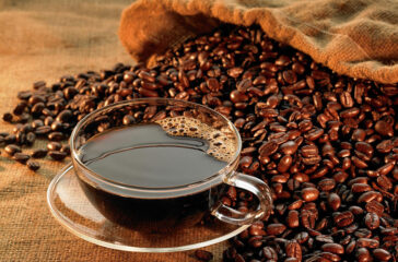 glass-coffee-cup-with-beans-on-warm-jonathansloane