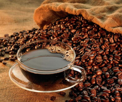 glass-coffee-cup-with-beans-on-warm-jonathansloane