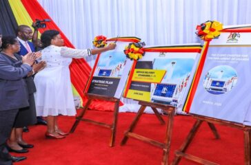 Hon. Afoyochan cuts a ribbon to mark the launch of the Strategic Plan Hon. Afoyochan cuts a ribbon to mark the launch of the Strategic Plan