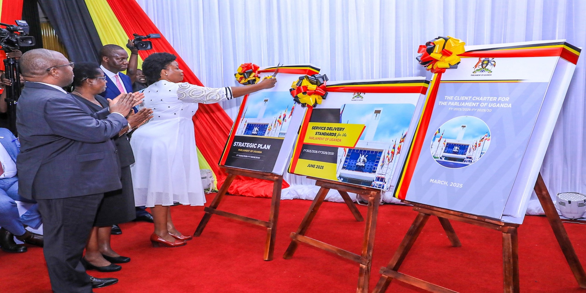 Hon. Afoyochan cuts a ribbon to mark the launch of the Strategic Plan Hon. Afoyochan cuts a ribbon to mark the launch of the Strategic Plan
