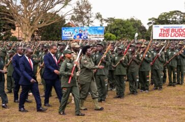 Commissioner Patriotism Helen Seku inspecting the parade during the passout of over 2500 patriotism students and teachers of Kings College Buddo on Saturday. PPU Photo