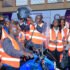Rotary District 9213 Governor, Dr. Gerald Obai putting a helmet on a boda boda cyclist (1)