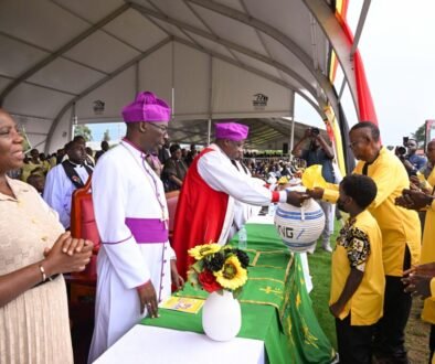 Prof Kamuntu presents the offertory basket to the Bishops during his thanksgiving in Sheema on Saturday. PPU Photo