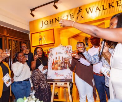 UBL executives join Christopher Kafure for a celebratory toast following the launch of the Gift the Cheer of the Season catalogue at House of Walker, Wandegeya. (2)